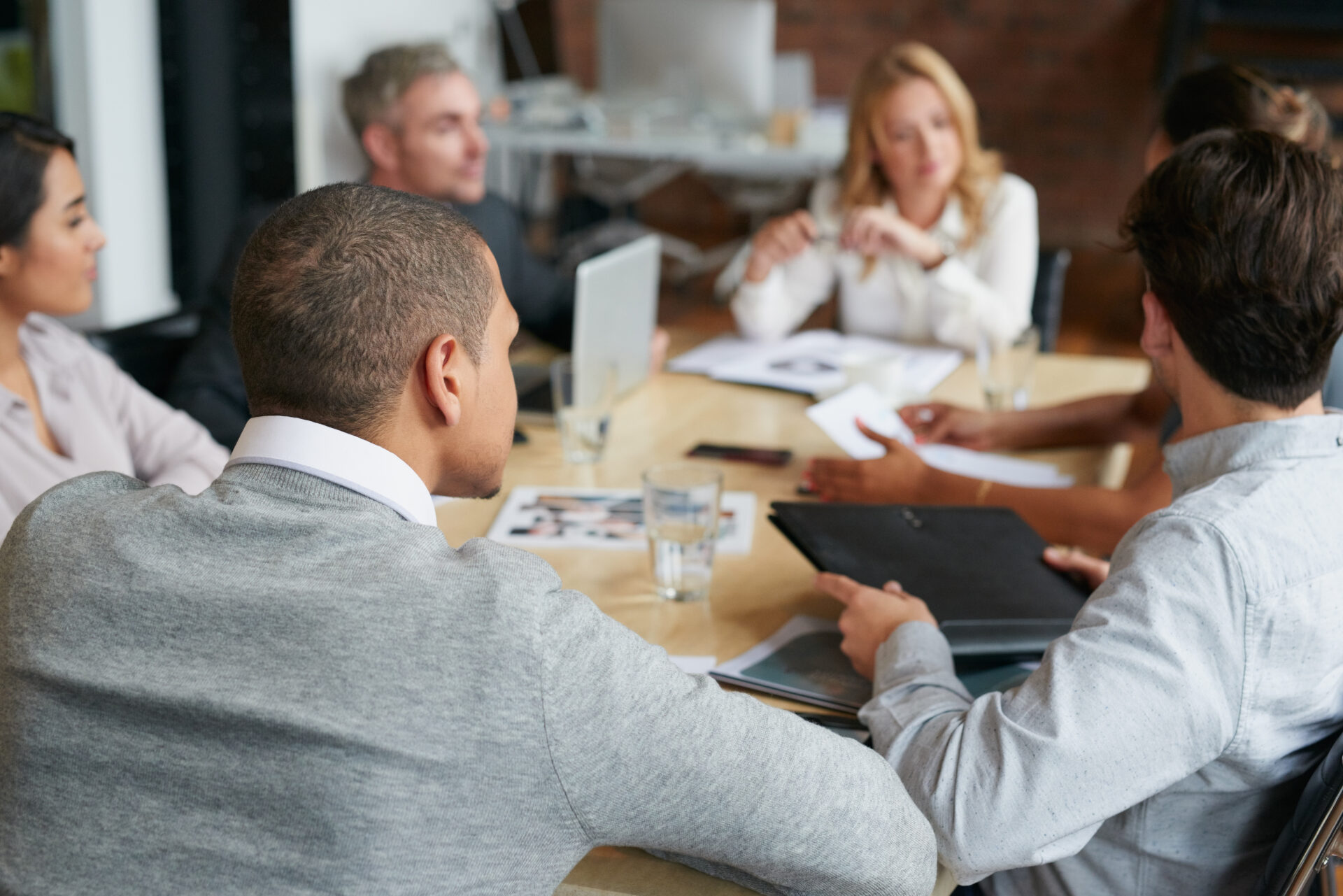 Ambitious business people meeting at boardroom table discussing